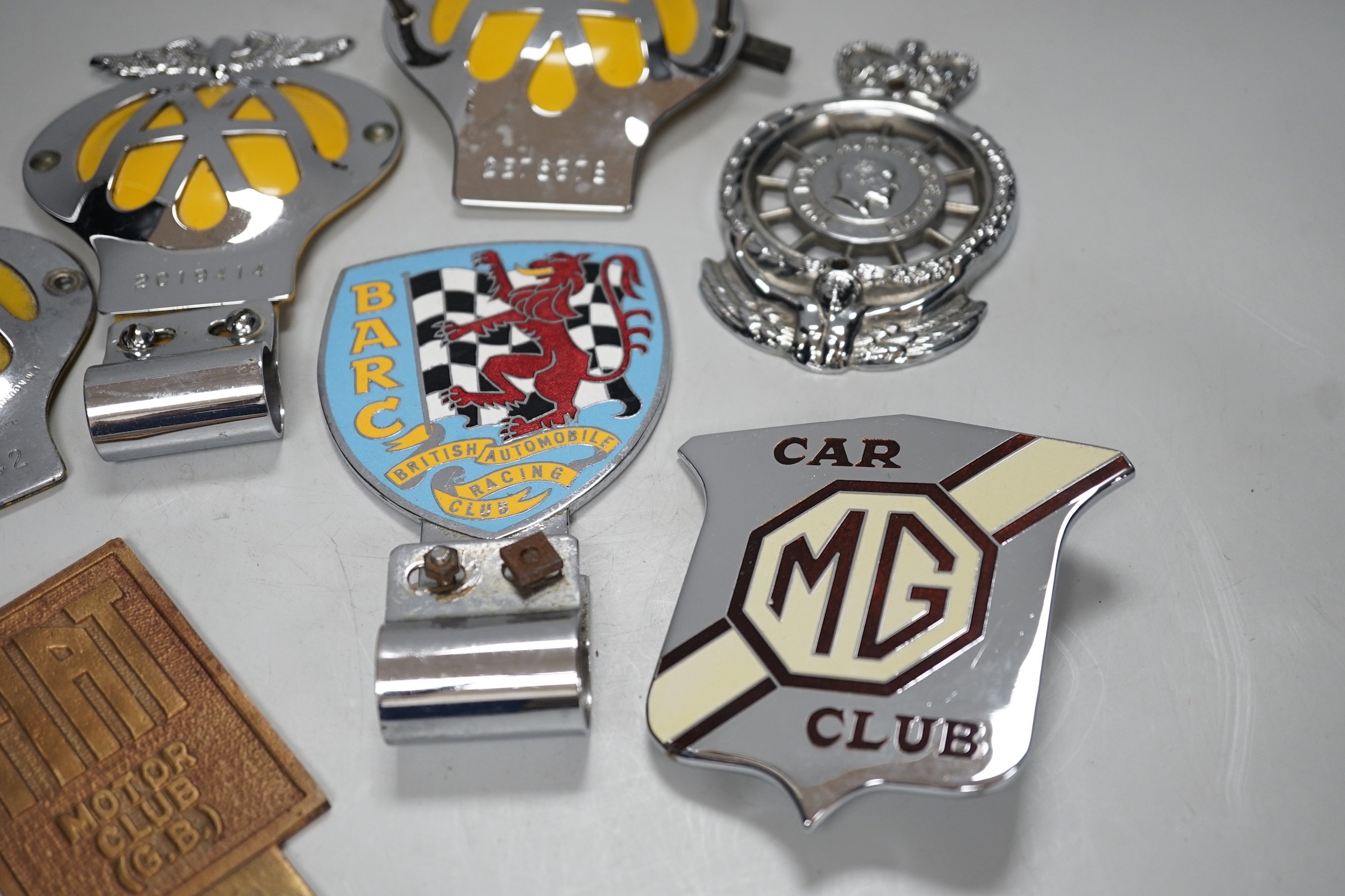 Seven car badges: Fiat motor club, British automobile racing club, MG club, the automobile club and three AA badges